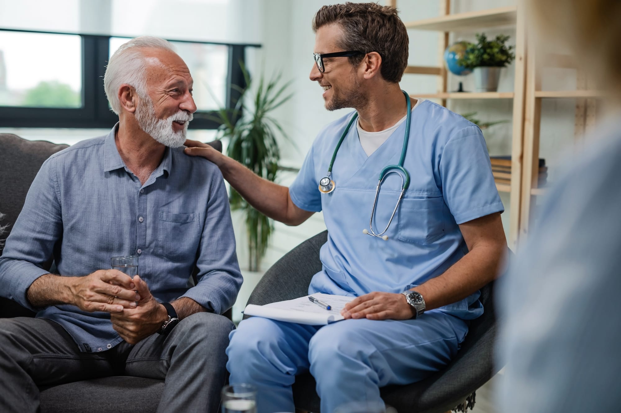 Elderly HIV patient speaking with his doctor