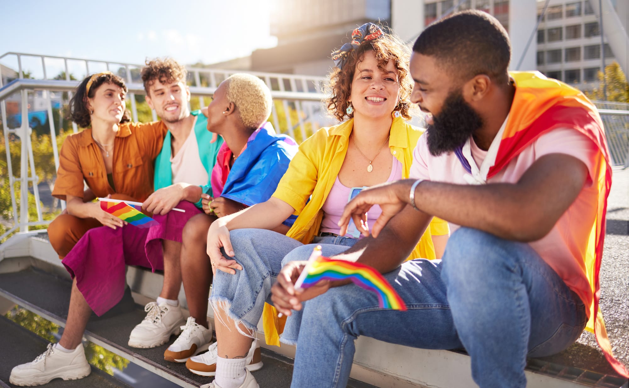 Group of young LGBTQIS identifying people chatting with each other.